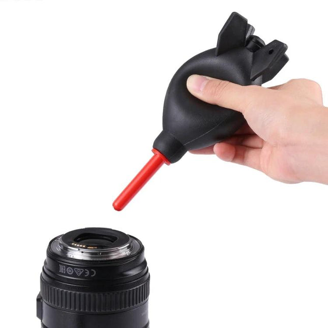 Rubber Dust Blower Ball for Cleaning Cameras and Electronics blowing dust from a camera lens, silicone bulb with red nozzle