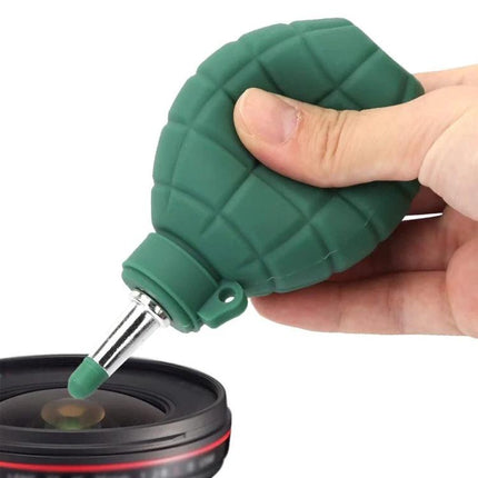 Grenade Rubber Dust Blower for Camera Lenses and Electronics — green silicone grenade blower removing dust from camera lens