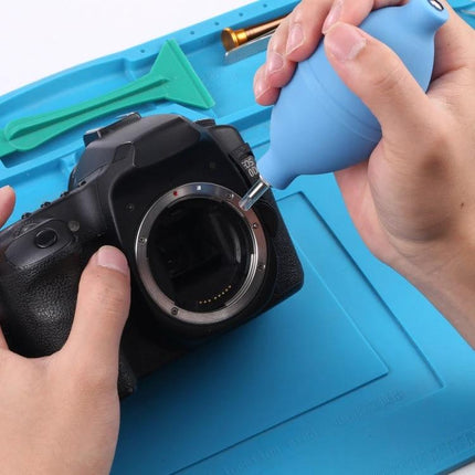 Mini Rubber Air Dust Blower for Electronics Cleaning gently removing dust from a camera sensor area during maintenance