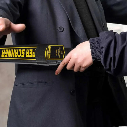 Portable Hand-Held Metal Detector for Security Screening being used to scan a person at an event, handheld wand detects concealed items