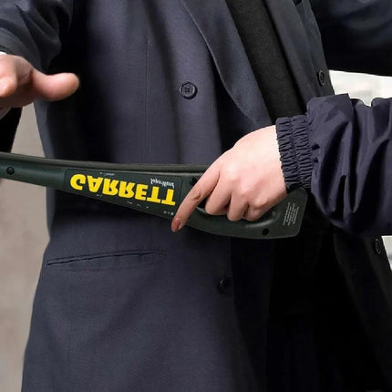 Portable Hand-held Metal Detector for Security Inspections being used to scan a person at an entry checkpoint