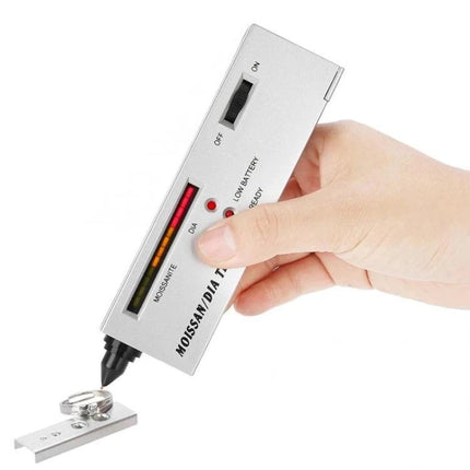 Portable Diamond and Moissanite Tester for Everyday Gem Checking handheld device testing a ring on a metal plate, compact portable gem verifier