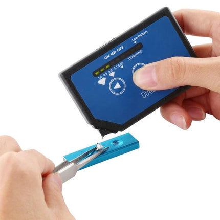 Compact Portable Diamond Selector for Quick Gem Testing handheld device checking a loose diamond on tweezers