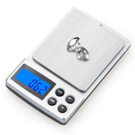 Digital Pocket Scale 300g Capacity For Precise Home Weighing showing stainless steel pan, blue backlit display reading 0.62 g and two gemstones on scale