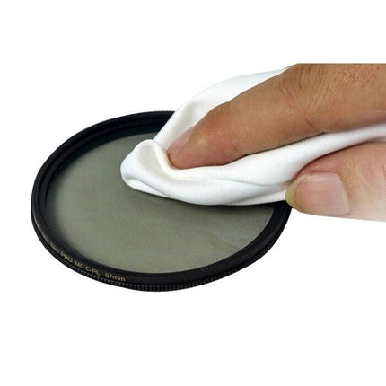 100 Pack Soft Cleaning Cloths for Eyeglasses and Screens gently wiping a camera lens filter to remove smudges and fingerprints