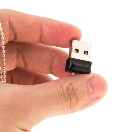 8GB Mini USB Flash Drive with Keychain for Computer Storage held between fingers, compact black USB drive on a keychain for pocketable file transfer