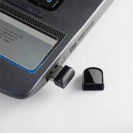 Compact 32GB USB Flash Drive with Keychain for Portable Storage plugged into laptop USB port with cap removed, small keychain storage drive