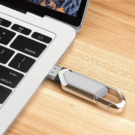 Compact 2GB Grey Keychain USB Flash Drive for Daily File Storage plugged into a laptop USB port, compact grey keychain design for portable file transfer