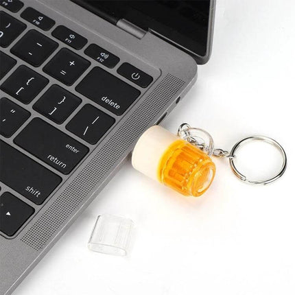 Stylish 16GB USB Flash Drive with Beer Keychain for Portable Storage - amber beer mug USB on keyring next to laptop