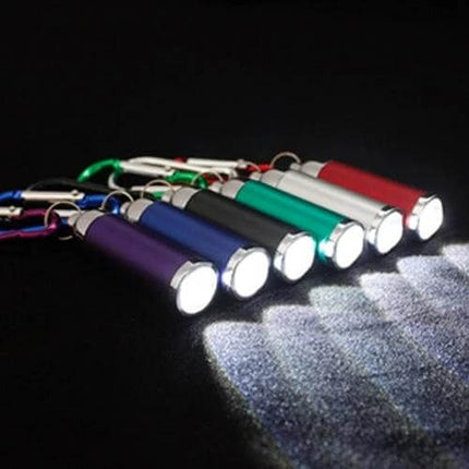 LED Flashlight With Carabiner Buckle For Camping And Emergency Use - compact keychain LED flashlight in multiple colors clipped to carabiners