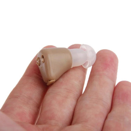 Axon Rechargeable In-The-Ear Hearing Aid with Volume Control held in hand, compact beige digital hearing device