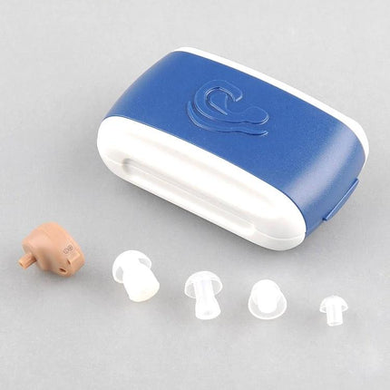 Compact In-Ear Hearing Aid for Everyday Sound Amplification with blue charging case and multiple ear tips, discreet in-ear beige device