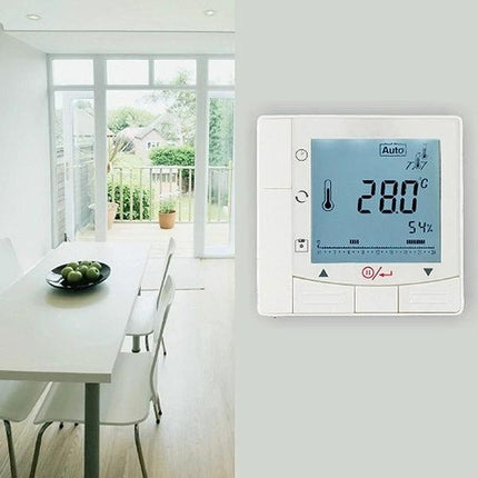 Programmable Thermostat for Room Temperature Control in Air Conditioning shown mounted with digital display next to bright dining area