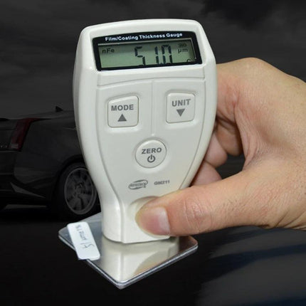 Benetech Coating Thickness Gauge for Metal Surfaces and Films measuring paint thickness on a car panel, handheld inspection device showing 510 µm