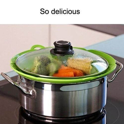 Spill Proof Silicone Pot Cover Prevents Boil Overs Fits 6 to 9.5 in - green silicone lid on pot with steamed vegetables, center vent open