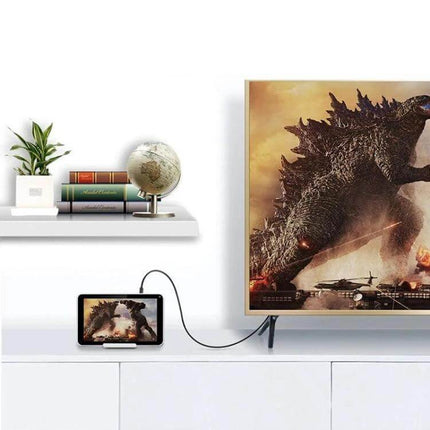 Coiled Micro HDMI to HDMI Cable with Gold Plating, 60cm Extendable connecting a tablet to a TV showing a movie scene