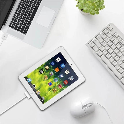 USB Cable for Everyday iPhone and iPad Charging at Home — flexible white charging cable powering iPad on desk setup