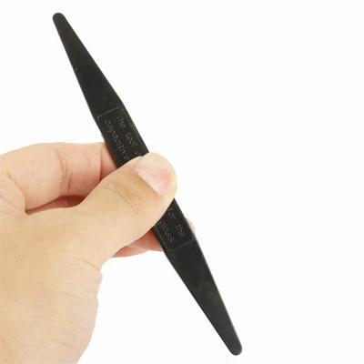 Tool for Separating Capacitive Screens on Mobile Phones black plastic pry tool held in hand for safely separating phone touch screen and LCD