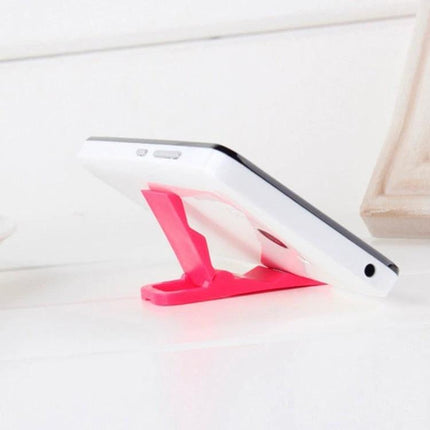 Compact Mini Universal Phone Holder for All Smartphones, 200-Piece Pack - pink stand holding white smartphone on desk for hands-free viewing