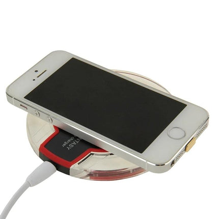 Convenient Charging Pad for Everyday Home Phone Use on a bedside desk charging an iPhone wirelessly with Qi-compatible pad