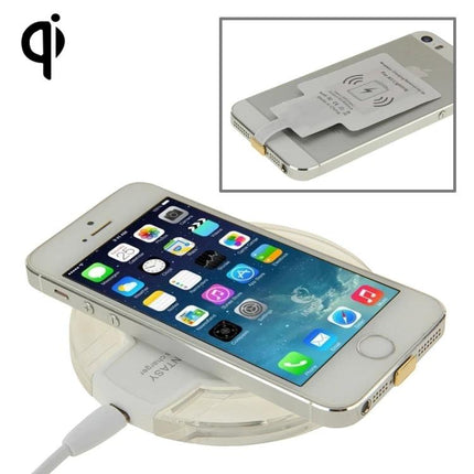 Convenient Charging Pad for Everyday Home Phone Use showing an iPhone on a Qi wireless charging pad on a bedside table