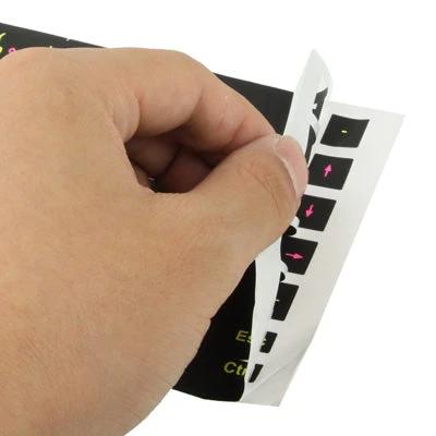 Arabic Keyboard Layout Stickers for Laptops and Desktops - hand peeling black sticker sheet showing Arabic characters for keyboard overlay