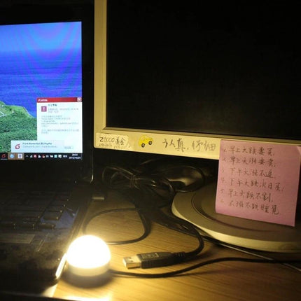 Essential USB light for daily home and travel use glowing beside laptop and monitor, USB-powered plug-and-play reading lamp for travel and desk