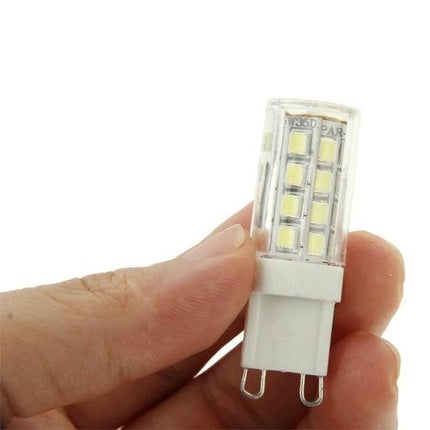 Warm White LED Light for Home and Studio Settings - compact G9 LED bulb held between fingers showing warm white LED chips