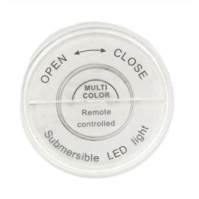 Versatile Light for Everyday Home Mood Settings - top view of round multi-color remote-controlled submersible LED light with open/close markings