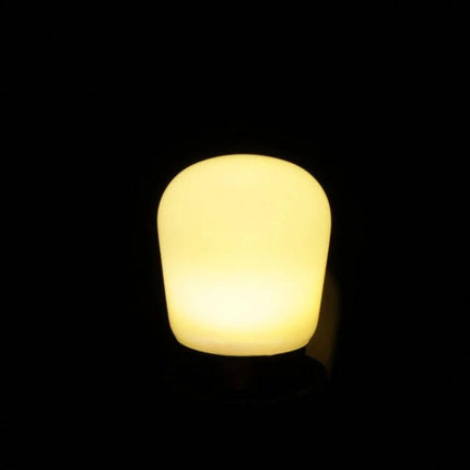 Compact Warm White LED Bulb for Everyday Home Lighting glowing in dark, warm bedside lamp illumination