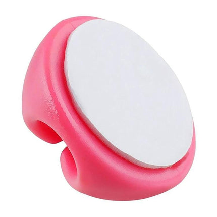 Keep Your Home Desk Cables Organized With These Clips — pink adhesive cable clip holding headphone or charger cable, low-profile desk cable organizer