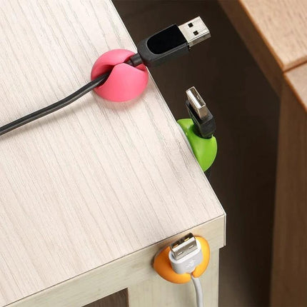 Keep Your Home Desk Cables Organized With These Clips - colorful adhesive cable clips holding USB cords on desk edge