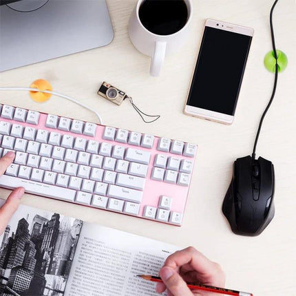 Keep Your Home Desk Cables Organized With These Clips - pink keyboard, mouse, phone and adhesive cable clips on tidy desk
