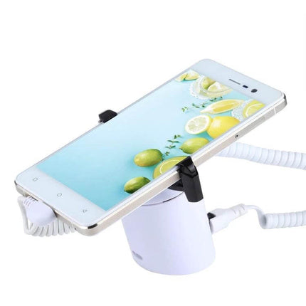 Cylindrical Display Stand with Anti-Theft Alarm for Smartphones showing white phone mounted, charging cable and coiled security tether attached
