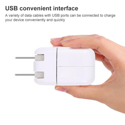 USB Adapter for Everyday Mobile Charging on the Go - compact white wall charger held in hand, USB port for travel and commuting