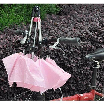 Universal Foldable Stainless Umbrella Mount For Bike Angle Adjustable mounted on bike handlebars with folded pink umbrella and adjustable angle