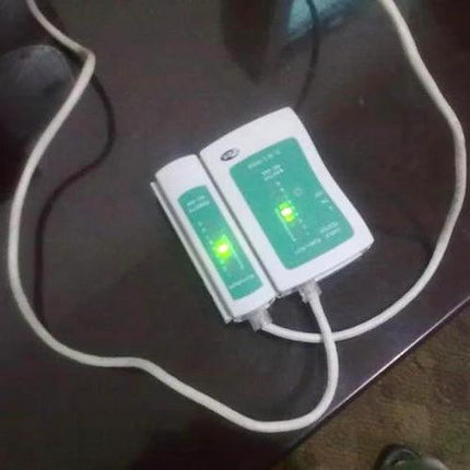 RJ45 and RJ11 Network Cable Tester for Ethernet Wiring Checks showing two modules with green LEDs and connected Ethernet cable