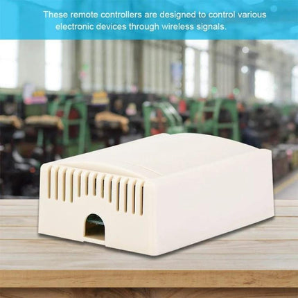 Wireless Remote Control System for Device Switching and Operation compact white receiver module shown on wooden surface in factory background
