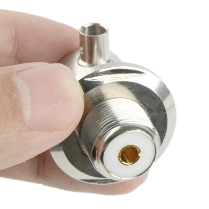 UHF Female Elbow Adapter with RG316 Cable for Antenna Use - close-up of 90-degree connector held between fingers, showing threaded UHF female jack and gold center pin