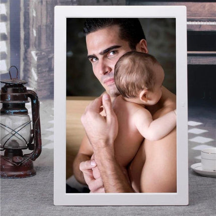 17-Inch Digital Photo Frame for Viewing Photos and Videos showing a white LED frame displaying a father holding his baby in a home setting