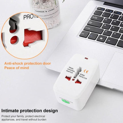 Universal Travel Adaptor for Worldwide Electrical Outlets compact white adaptor with anti-shock protection near laptop