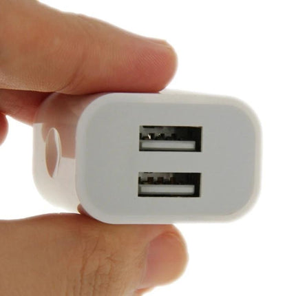 Universal Charger for Everyday Mobile and Tablet Use - compact white dual USB wall adapter held between fingers
