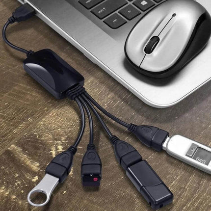 Universal Four-Port USB Hub for Connecting Computer Devices showing hub plugged into laptop with mouse and four USB devices connected