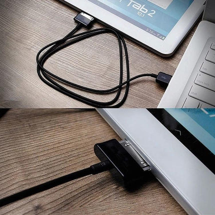 Keep your Samsung tablet charged for everyday tasks at home — black charging cable connected to Galaxy Tab and laptop on wooden desk