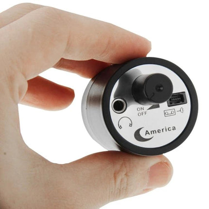 Home Ear Device for Hearing Through Walls Daily compact round audio sensor held between fingers for discreet wall listening