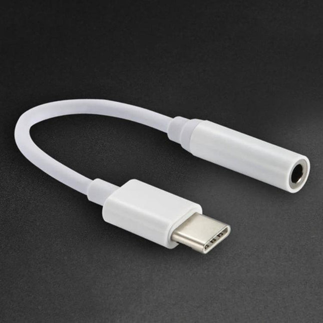 Compact Adapter for Connecting Headphones to USB-C Devices — white USB-C to 3.5mm headphone adapter on dark background