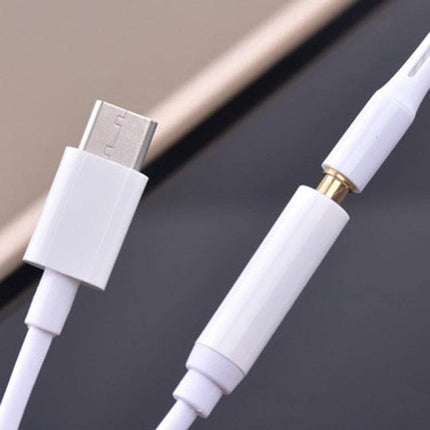 Compact Adapter for Connecting Headphones to USB-C Devices showing white USB-C to 3.5mm audio connector for music and calls