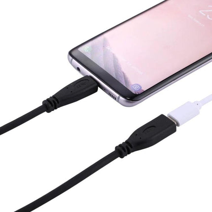 Versatile USB-C Adapter Cable for Daily Device Connections shown linking a smartphone and charging/data transfer on a desk