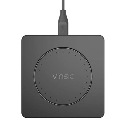 Keep your devices charged daily with the Vinsic Wireless Pad — compact black Qi wireless charging pad on desk