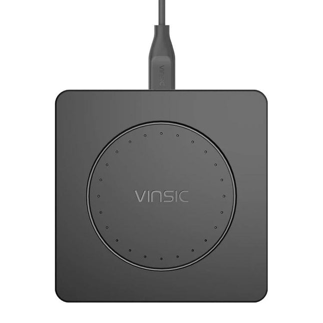 Keep your devices charged daily with the Vinsic Wireless Pad — compact black Qi wireless charging pad on desk